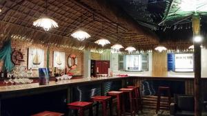 a bar with red stools in a restaurant at Palmira Beach Resort & Spa in Mui Ne