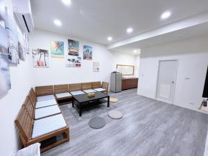 a living room with a couch and a table at 逢甲沐旅 in Taichung