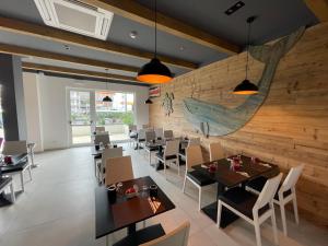 ein Restaurant mit Holzwänden, Tischen und Stühlen in der Unterkunft Oasis White Hotel in Sal Rei