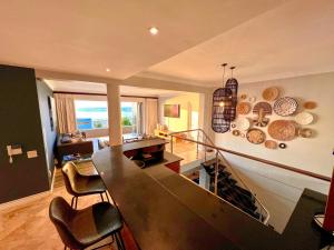 a kitchen and living room with a table and chairs at One On Houghton in Cape Town