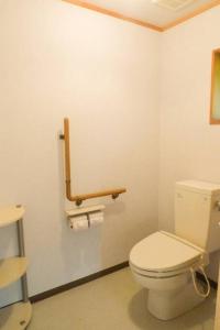 a bathroom with a white toilet in a room at kaso Space kamiyama Log House 