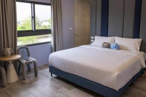 Postel nebo postele na pokoji v ubytování 鴝花甜點民宿 QuHua Sweety B&B