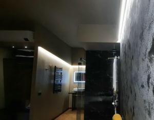 a hallway with a bathroom with a shower and a sink at Il Vicolo Luxury Rooms in Nettuno