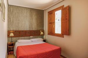 Łóżko lub łóżka w pokoju w obiekcie Barranco de la Olla by Apartamentos Arnedillo