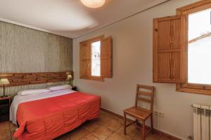 Łóżko lub łóżka w pokoju w obiekcie Barranco de la Olla by Apartamentos Arnedillo