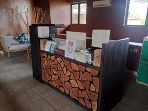 a counter with a pile of fire wood at Trois Ore Residences & Green Earth Bistro in Ibadan