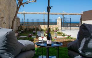 a bottle of wine on a table next to two chairs at MariMar in Balíon