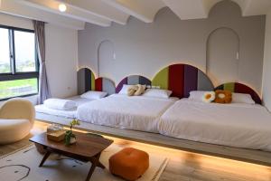 Postel nebo postele na pokoji v ubytování 鴝花甜點民宿 QuHua Sweety B&B