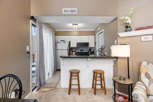 a kitchen and living room with a counter and stools at Cozy fireplace home at Wintergreen all amenities in Lyndhurst