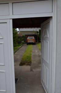 an open garage door with a truck in the driveway at Apartman K 99, Karadjordjeva 99, Bela Crkva in Bela Crkva