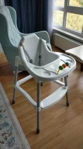 a white high chair with a tray on it at Tarabya Family Suit Acibadem Hospital in Istanbul