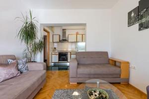 a living room with a couch and a table at Apartmani Jelena in Omiš