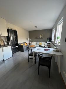 a kitchen and living room with a table and chairs at Varmi Guesthouse Apartments & rooms in Hveragerði