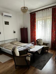 a bedroom with a bed and a table and chairs at Kis Gell&eacute;rt Guesthouse in Budapest