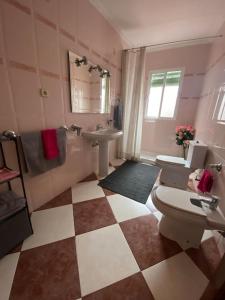 a bathroom with a toilet and a sink at Casa Cumbres in Cumbres de San Bartolomé