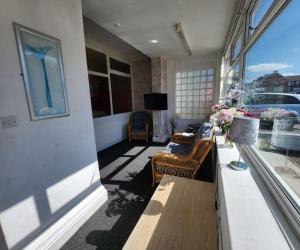 a living room with a couch and a window at The Moorfield in Blackpool