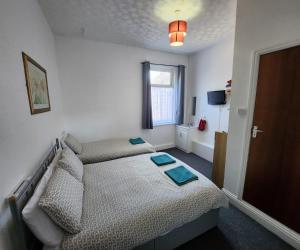 a small bedroom with a bed and a window at The Moorfield in Blackpool