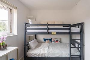 two bunk beds in a room with a bed at Monalychee in London