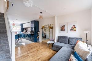 a living room with a couch and a kitchen at Monalychee in London