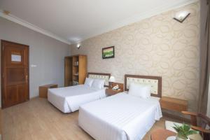 Postel nebo postele na pokoji v ubytování Sammy Hotel