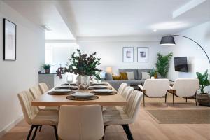 a dining room and living room with a table and chairs at Magno Apartments Castelar in Seville