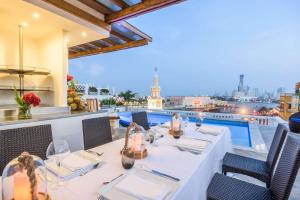 a restaurant with a table and a view of the city at NH Royal Urban Cartagena in Cartagena de Indias