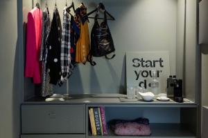 a walk in closet with a book shelf and clothes at chic&basic dot in Madrid
