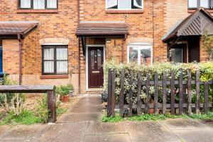 a wooden fence in front of a brick house at Monalychee in London