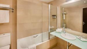 a bathroom with a sink and a shower at NH Madrid Lagasca in Madrid