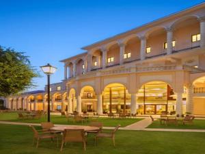a large building with a table and chairs in front of it at DLF City Club 5 in Gurgaon