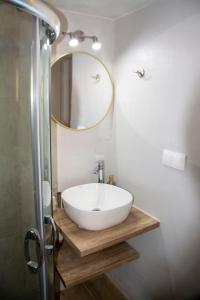 a bathroom with a white sink and a mirror at MariMar in Bali