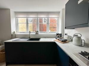 a kitchen with a sink and a window at The Loft, NEW, Stylish Maisonette, Central, Private Location in Lewes