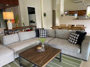 a living room with a couch and a coffee table at Nolan garden house in whitfield in Stratford