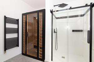 a bathroom with a shower and a glass door at Villa Beatrice by Locap Group in Izola