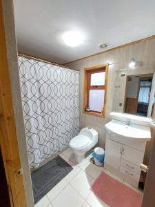 a bathroom with a toilet and a sink at Vichuquén Mágico in Vichuquén