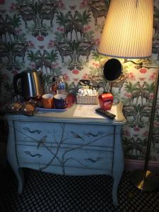 a blue dresser with a lamp on top of it at The Forester and Flower in Bath