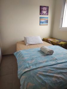 a room with two beds and a pillow on the floor at Dudger home in Yehud