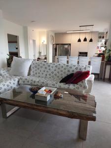 a living room with a couch and a coffee table at Dudger home in Yehud