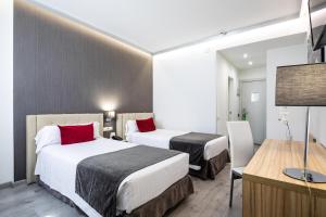 Postel nebo postele na pokoji v ubytování Sweet Hotel Renasa