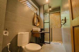 a bathroom with a toilet and a shower at Chandaka Borobudur in Magelang