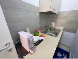 a small kitchen with a sewing machine on a counter at Sweet Stay in Fiumicino