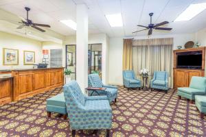 a waiting room with chairs and a flat screen tv at Days Inn by Wyndham Valdosta/Near Valdosta Mall in Valdosta
