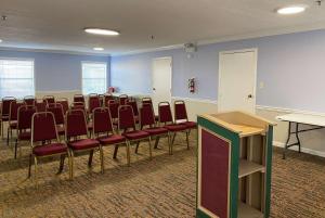 una sala de conferencias con sillas y un podio. en Super 8 by Wyndham Covington, en Covington