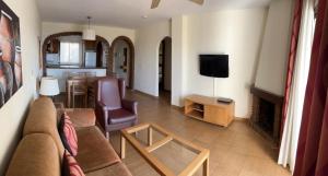 salon z kanapą, telewizorem i stołem w obiekcie Riviera del Mar apartment w mieście Mijas Costa
