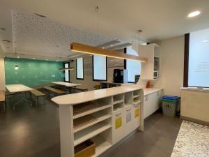 a kitchen with a counter and a dining room at Albergue Guiana in Ponferrada