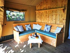 a couch in a room with a table at Il Girasole Country Village in Massignano
