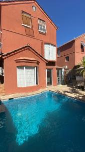 a large blue swimming pool in front of a house at Casa Fuerteventura in Santiago