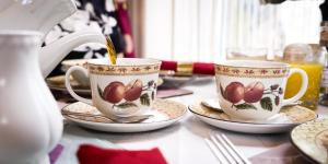 two tea cups and saucers on a table at Barbican House in York