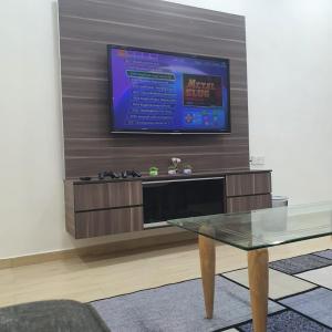 a living room with a tv and a coffee table at KuantanBukitSetongkolArea3R2B.HTAA/TOWN-5min only in Kuantan
