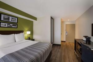 A bed or beds in a room at SureStay Plus by Best Western Mesa Superstition Springs